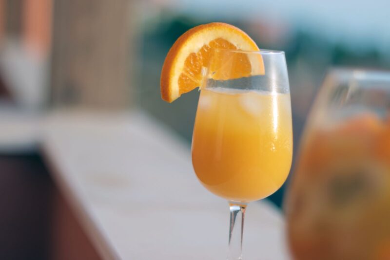 mimosa with an orange slice garnish