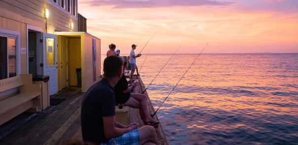 A row of fishing rods sitting on top of a boat photo – Free