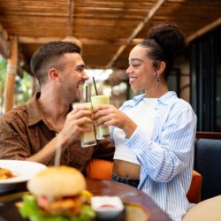 couple enjoying dining experience by the beach