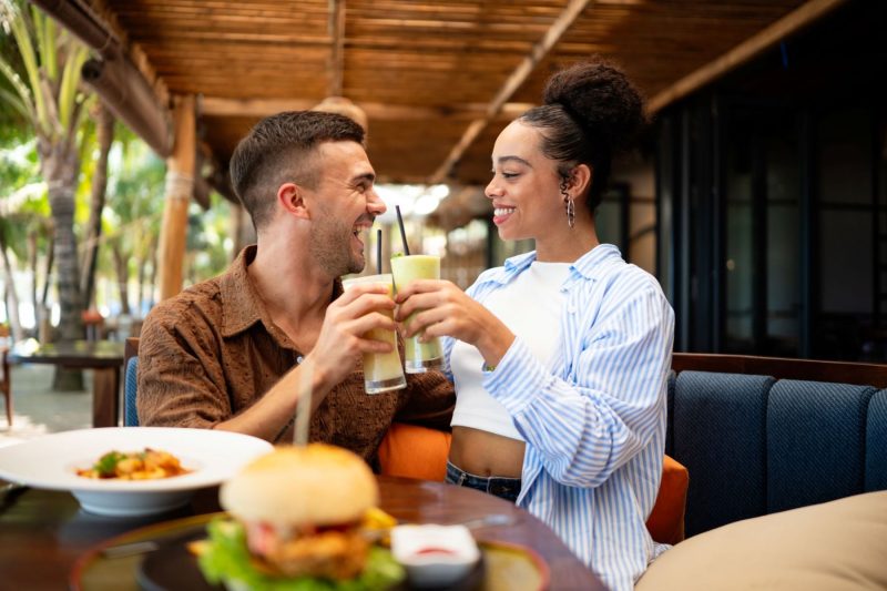 couple enjoying dining experience by the beach