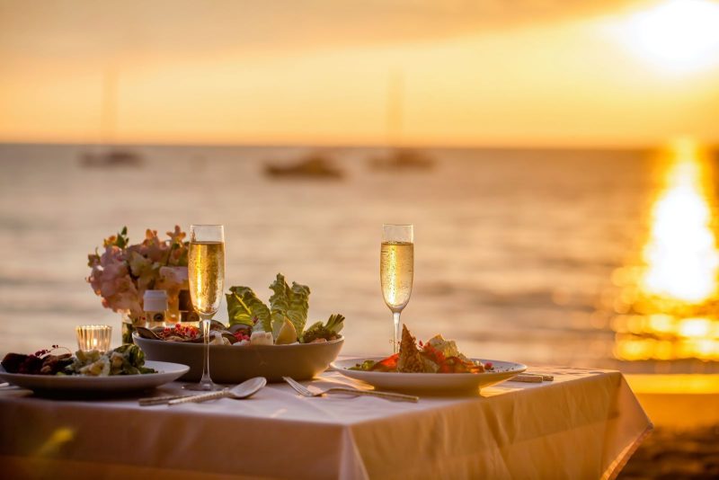 dining table by the water at sunset
